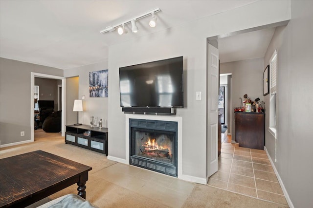 living room featuring rail lighting and light tile patterned floors