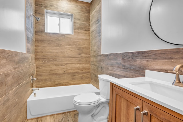 full bathroom with toilet, tiled shower / bath, and vanity