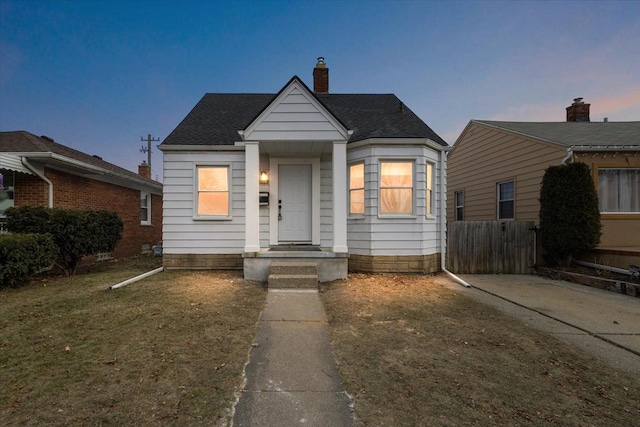 bungalow-style house with a lawn