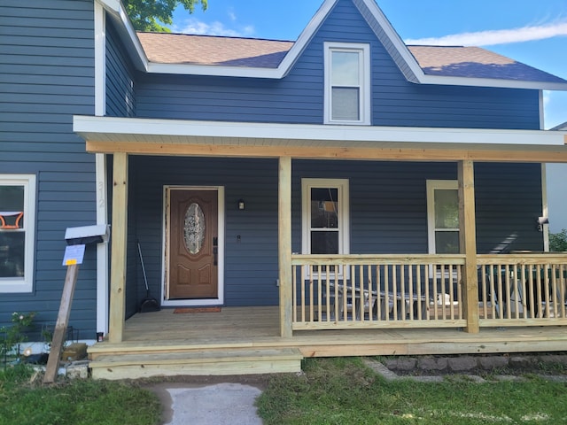 view of exterior entry with a porch