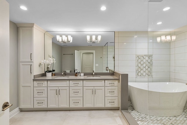 bathroom featuring a bathtub, vanity, and tile patterned flooring