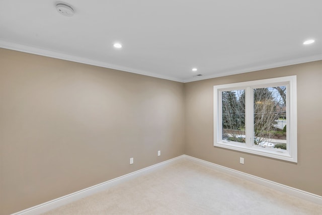 spare room featuring light carpet and ornamental molding