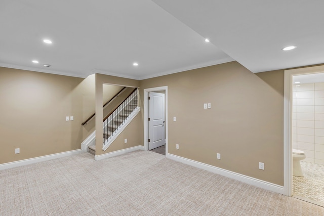 basement featuring crown molding and light colored carpet