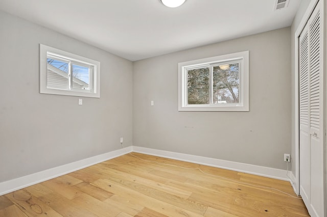 unfurnished bedroom featuring hardwood / wood-style floors and a closet