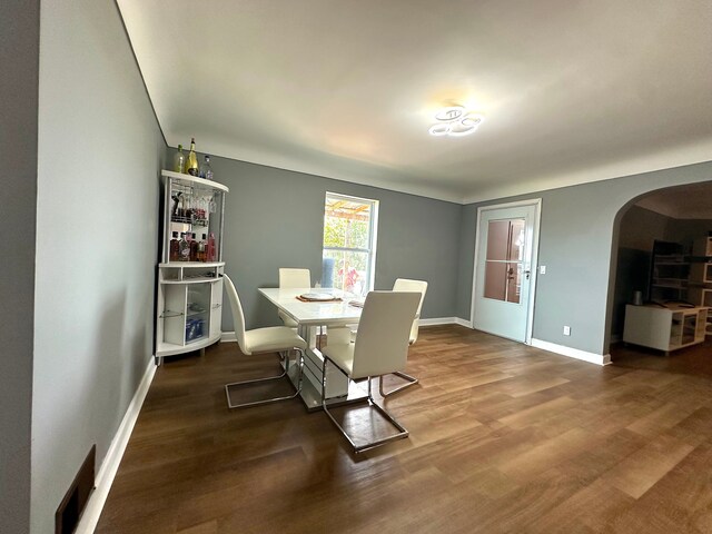 dining area with dark hardwood / wood-style flooring