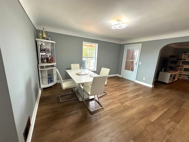 dining space with dark hardwood / wood-style floors