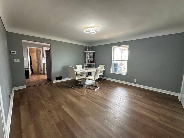 dining room with dark hardwood / wood-style floors