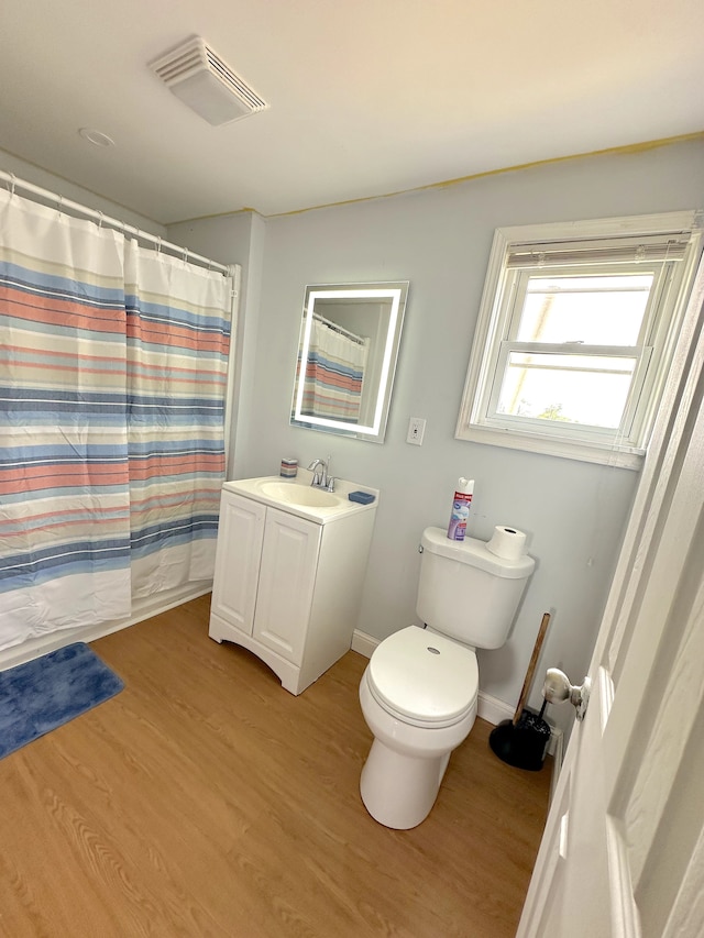 bathroom with hardwood / wood-style flooring, vanity, toilet, and a shower with curtain