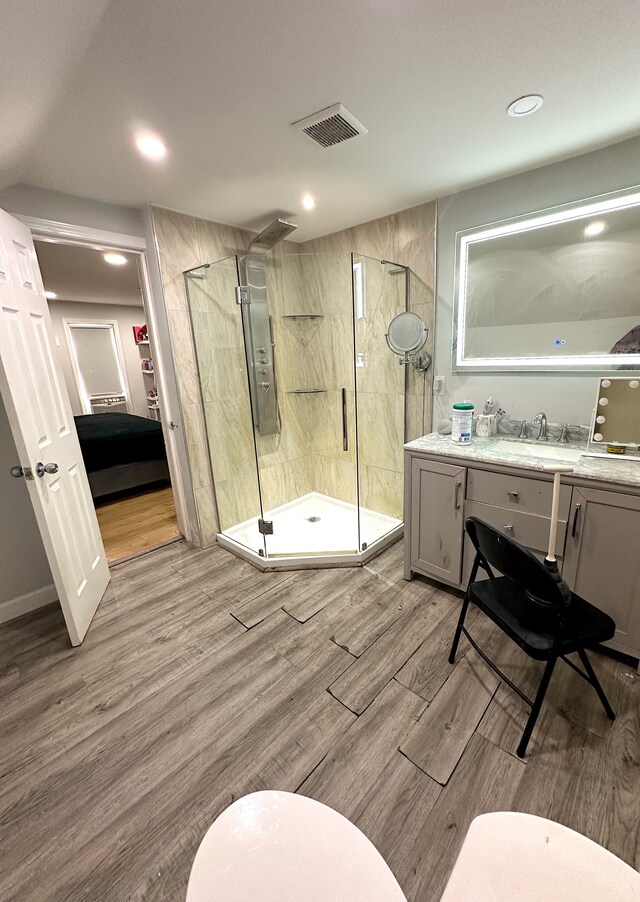 bathroom featuring vanity, walk in shower, and electric panel