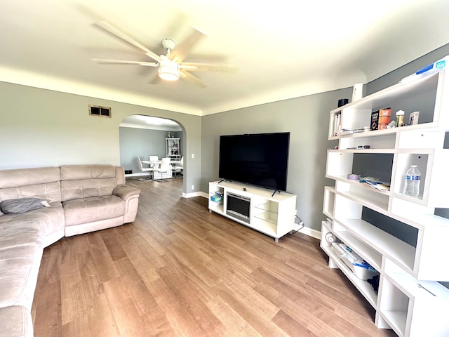 living room featuring light hardwood / wood-style flooring and ceiling fan