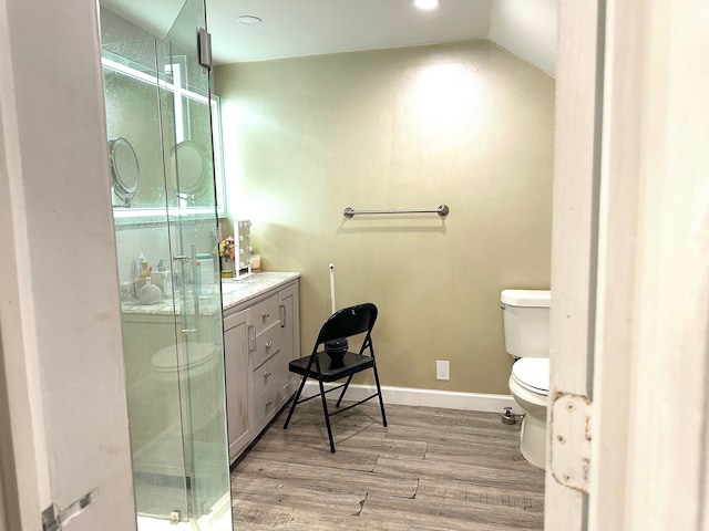 bathroom with vaulted ceiling, toilet, an enclosed shower, vanity, and hardwood / wood-style flooring