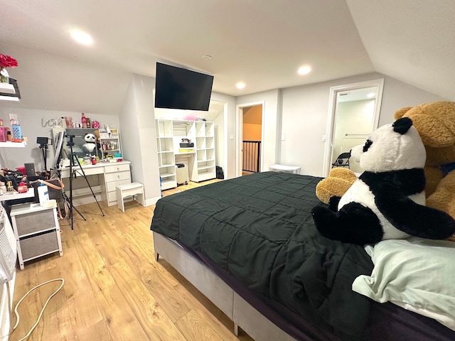 bedroom featuring vaulted ceiling and light wood-type flooring