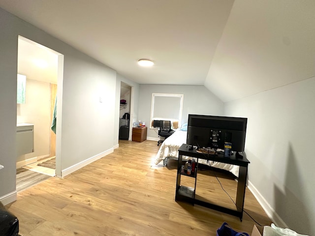 interior space with light hardwood / wood-style floors and lofted ceiling