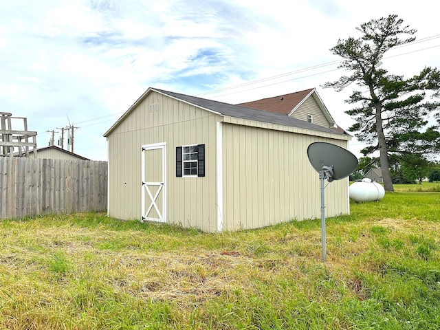 view of outbuilding featuring a lawn