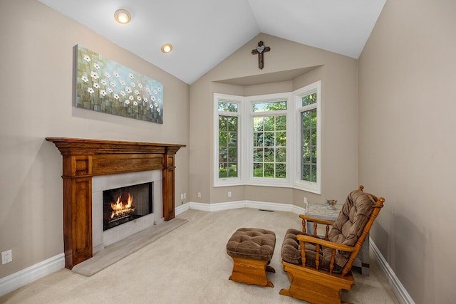 living area with light carpet and vaulted ceiling