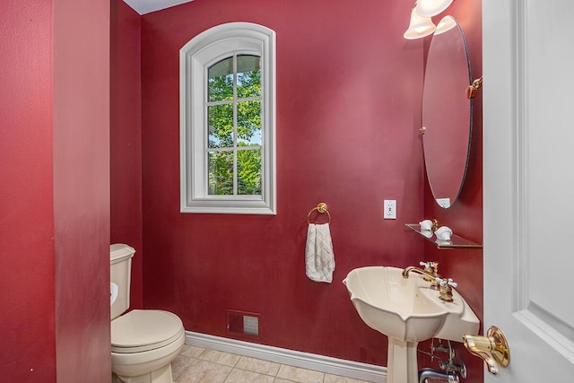 bathroom featuring tile patterned floors, toilet, and sink