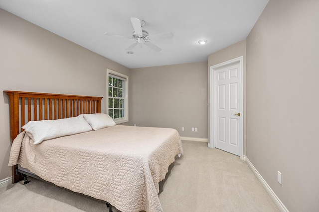 bedroom with light carpet and ceiling fan