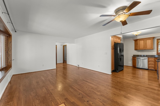 unfurnished living room with ceiling fan and wood-type flooring