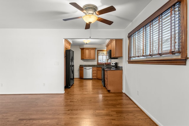 kitchen with stainless steel appliances, dark wood-type flooring, ceiling fan, and a healthy amount of sunlight