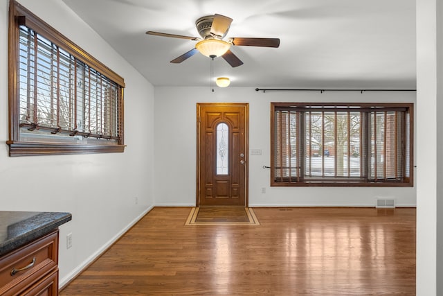 entryway with ceiling fan and wood-type flooring