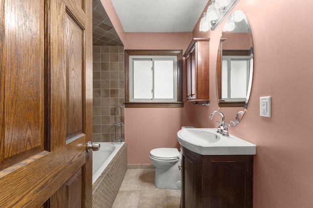 full bathroom featuring tiled shower / bath, tile patterned flooring, vanity, and toilet