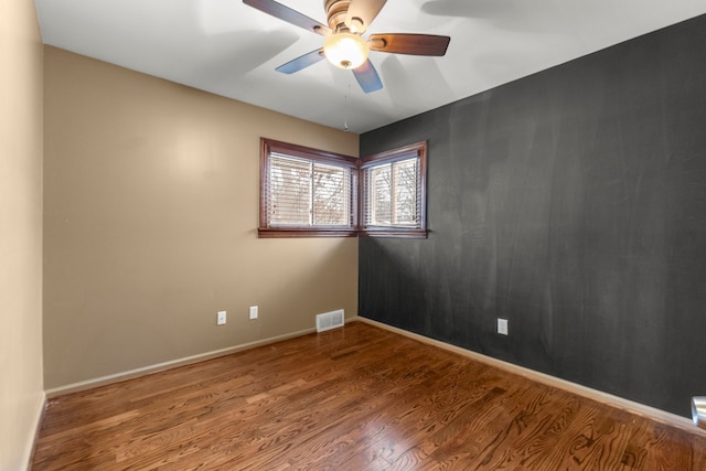 unfurnished room with ceiling fan and wood-type flooring