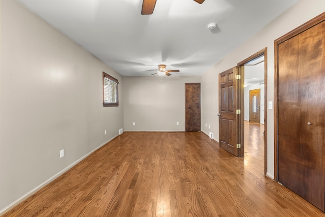 unfurnished room featuring ceiling fan and wood-type flooring