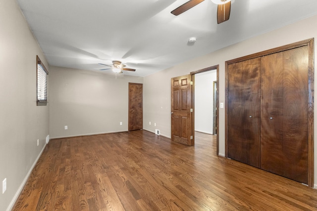 unfurnished bedroom featuring ceiling fan and hardwood / wood-style flooring