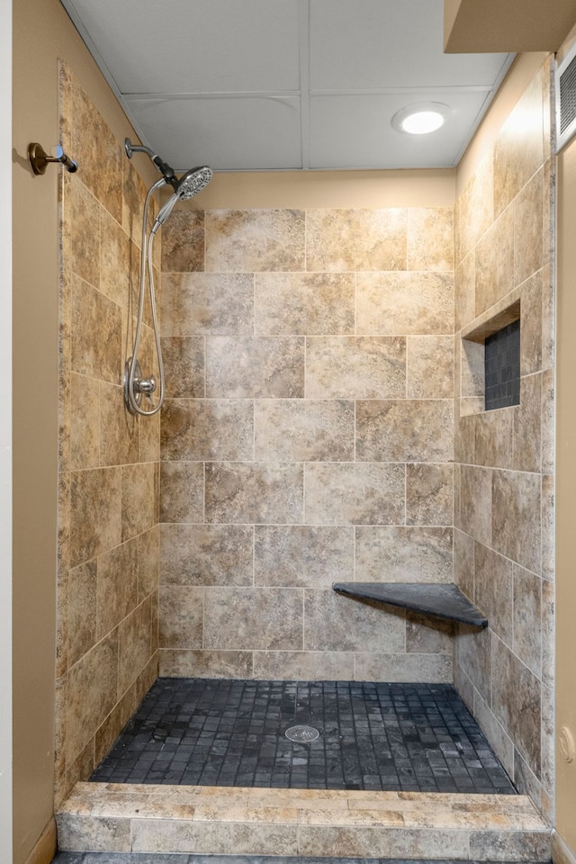 bathroom with tiled shower