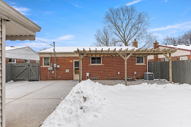 snow covered property with central air condition unit