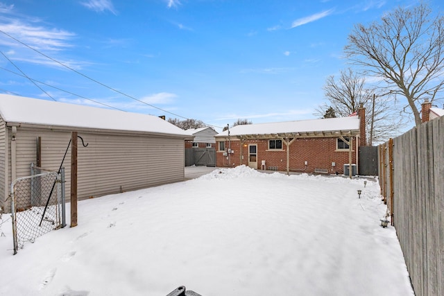 snowy yard featuring central AC