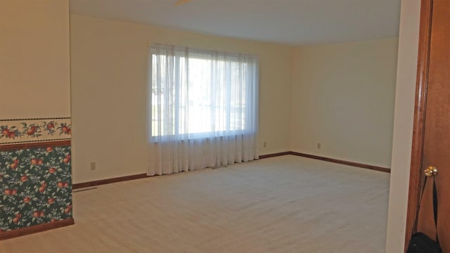 spare room with light carpet