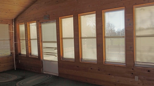 unfurnished sunroom featuring wooden ceiling and vaulted ceiling