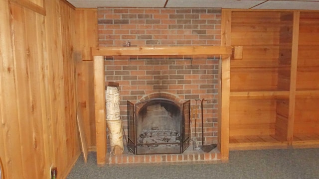 interior details with carpet flooring and wood walls