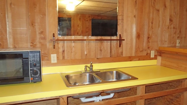 kitchen with wood walls and sink