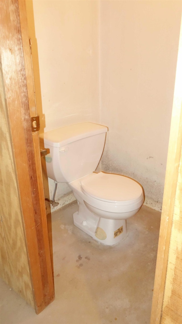 bathroom featuring toilet and concrete flooring