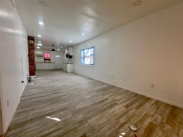 unfurnished living room with light hardwood / wood-style floors