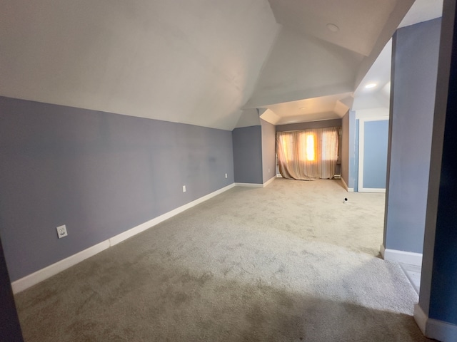 bonus room with carpet and vaulted ceiling