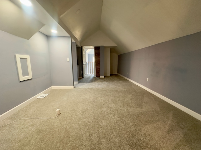 additional living space with carpet and vaulted ceiling