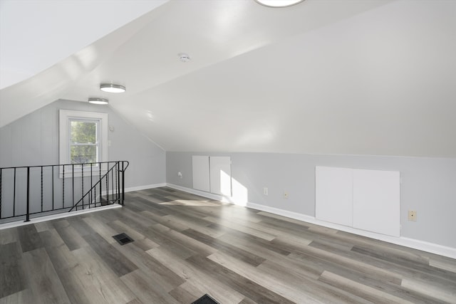 bonus room with hardwood / wood-style floors and lofted ceiling