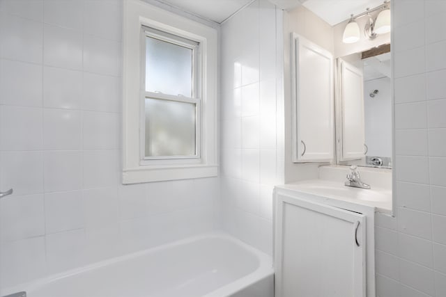 bathroom featuring vanity, shower / tub combination, and tile walls