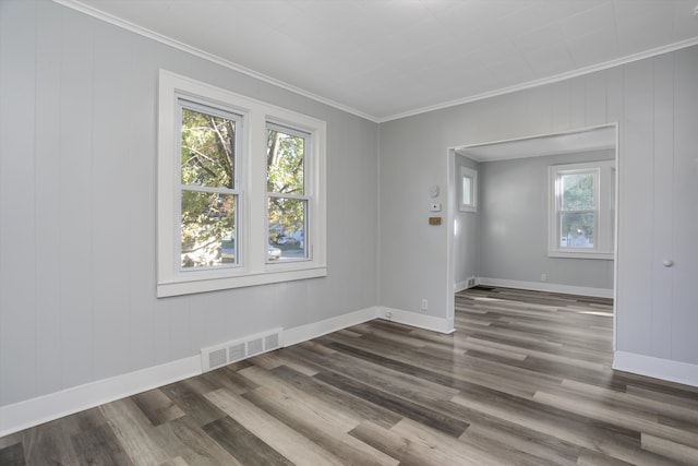 unfurnished room with crown molding and dark wood-type flooring