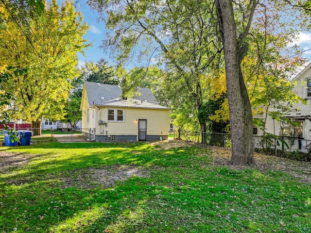 back of house with a yard