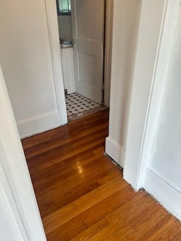 hallway with dark hardwood / wood-style flooring