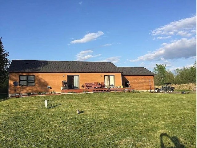 rear view of house featuring a lawn