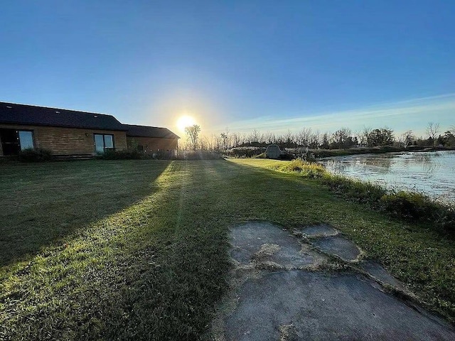 yard at dusk with a water view