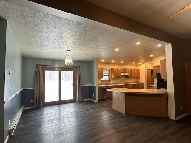 kitchen with kitchen peninsula, stainless steel dishwasher, a textured ceiling, dark wood-type flooring, and an inviting chandelier