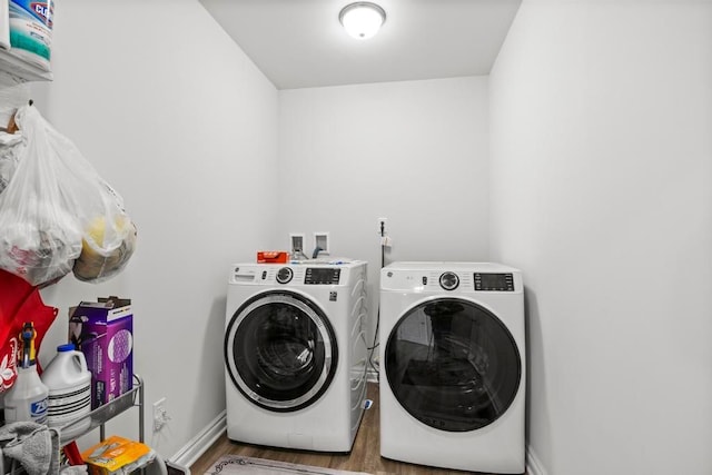 laundry room featuring hardwood / wood-style floors and washing machine and clothes dryer