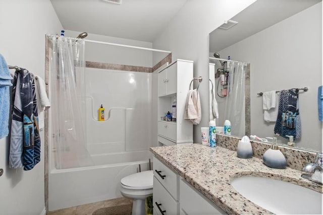 full bathroom featuring tile patterned flooring, vanity, toilet, and shower / bath combo with shower curtain