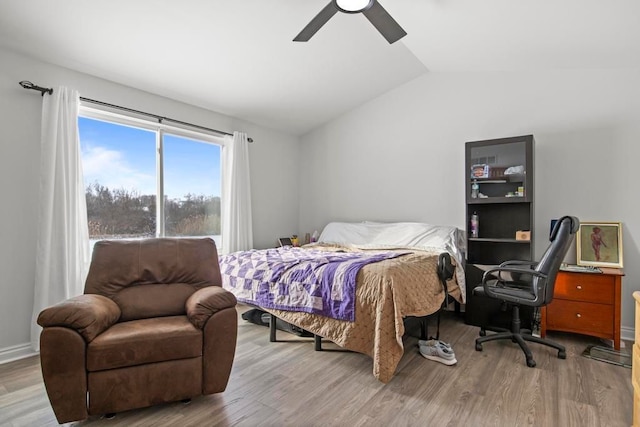 bedroom featuring light wood-type flooring, ceiling fan, and lofted ceiling